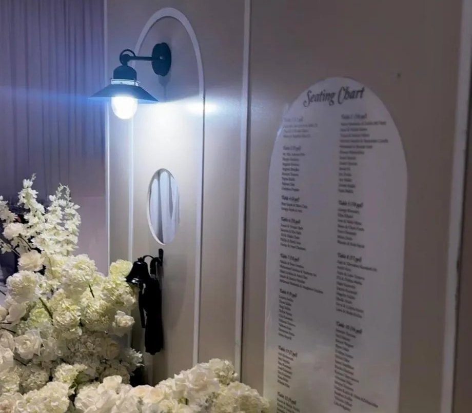Let's Bloom Florist welcome sign and escort card display at a wedding entrance