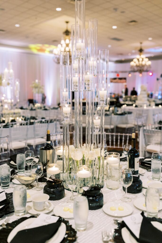 Let's Bloom Florist glass taper candelabra centerpiece with white roses on a reception table