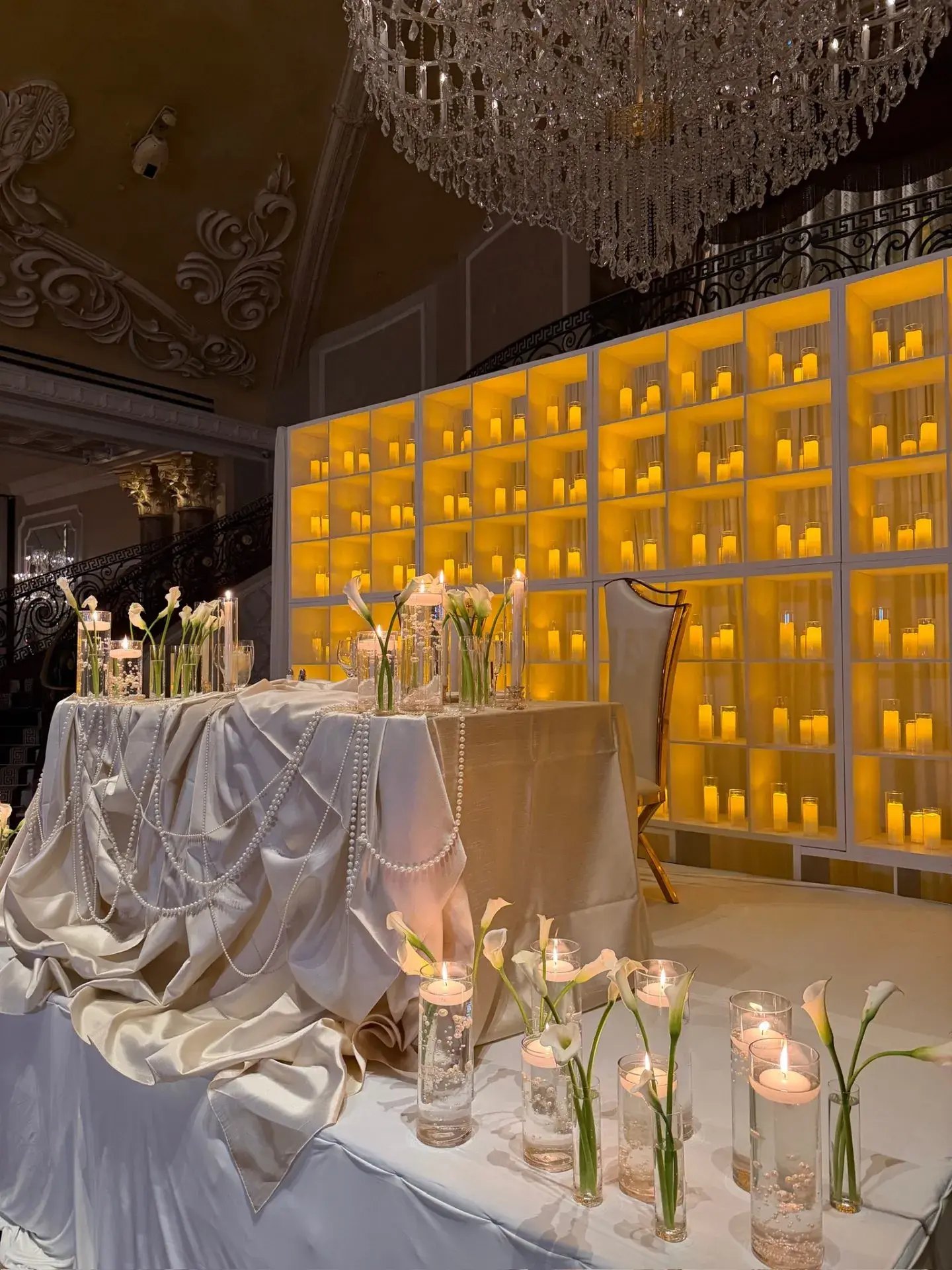 Sweetheart table with pearl linen and a glowing amber candle wall at The Venetian, NJ, by Let's Bloom Florist